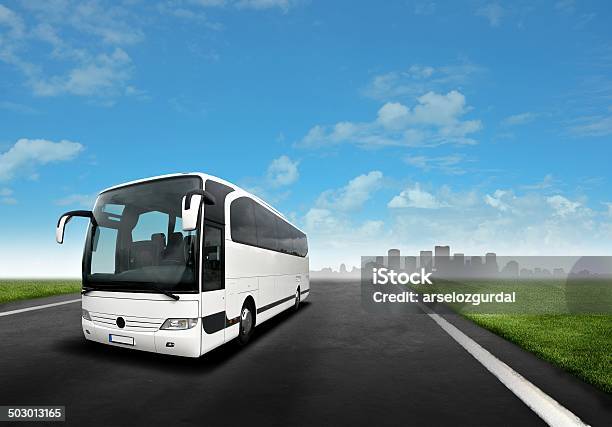 White Bus On The Road Stock Photo - Download Image Now - Coach Bus, Tour Bus, Environmental Conservation