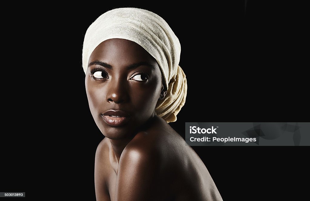 She's dedicated to keeping her skin healthy Studio shot of a beautiful woman wearing a headscarf against a black background 20-29 Years Stock Photo