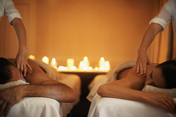 genießen sie eine gemeinsame massage - spa treatment health spa couple heterosexual couple stock-fotos und bilder
