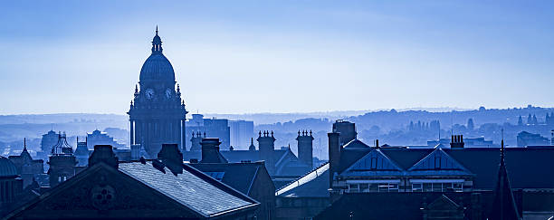 Leeds city centre skyline showing Leeds Town Hall and the rooftops of the city. Monochrome with cyanotype tint. 