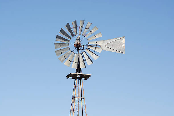 istock Metal Rustic Windmill On Farm Against Blue Sky 503017216