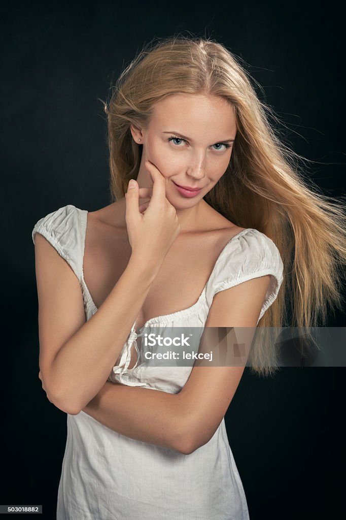 smiling blond girl smiling blond girl in white dress on black background 20-24 Years Stock Photo