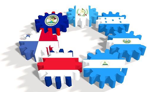 Central American Common Market association of seven national economies members flags on cog wheels. White backdrop