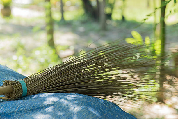 Coconut broom stick lay down of blue sheet.