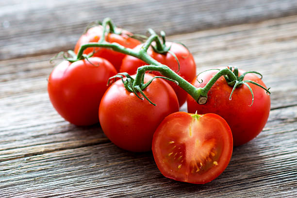 Fresh tomatoes on wood background Fresh tomatoes on wood background vine tomatoes stock pictures, royalty-free photos & images