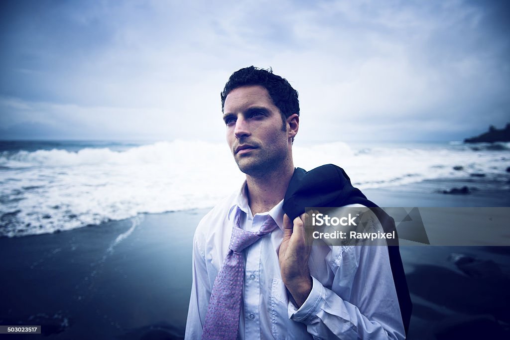 Businessman Thinking by the Beach with Serious Face Adult Stock Photo