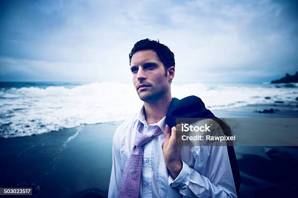Businessman Thinking By The Beach With Serious Face Stock Photo - Download Image Now