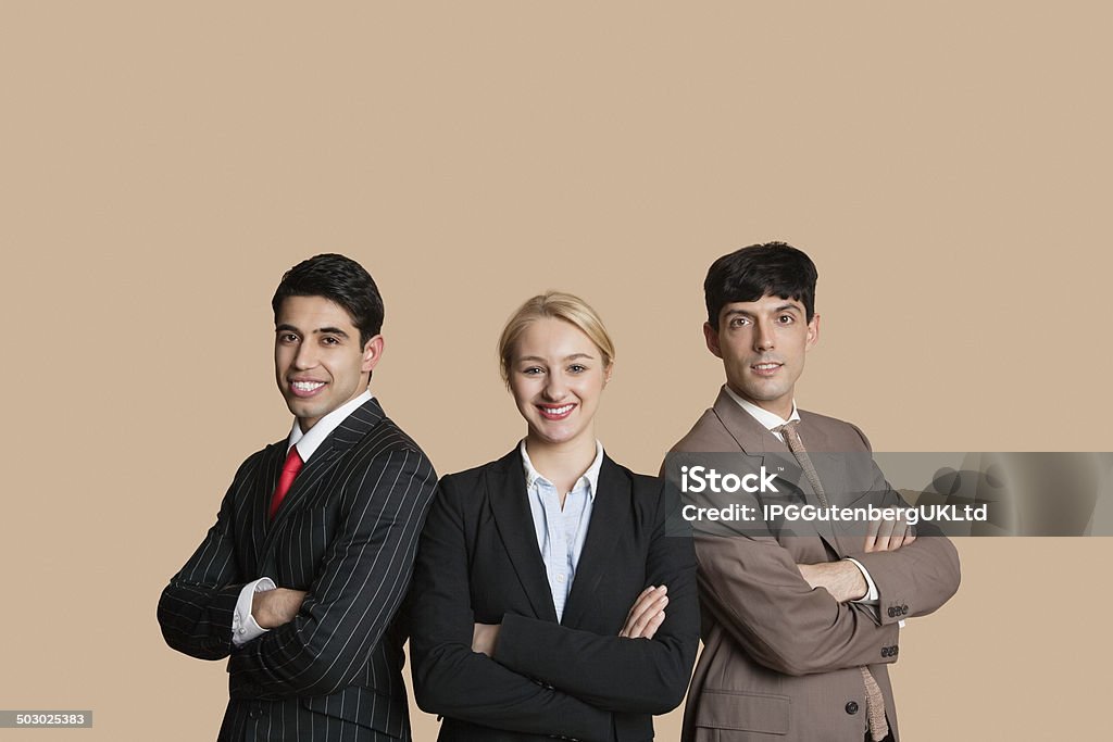 Portrait of Happy young person Portrait of young multiethnic team with arms crossed over colored background Businessman Stock Photo