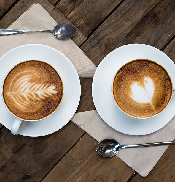 istock Cup of hot latte art coffee on wooden table 503025521