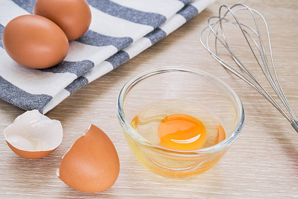 istock Fresh egg in bowl and metal whisk 503026231
