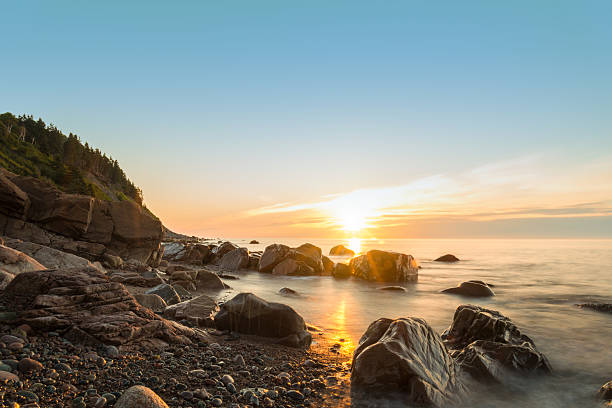 Ocean shore at sunrise Ocean shore at sunrise (Cape Breton, Nova Scotia, Canada) cabot trail stock pictures, royalty-free photos & images