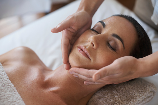 Shot of an attractive woman enjoying a face massage