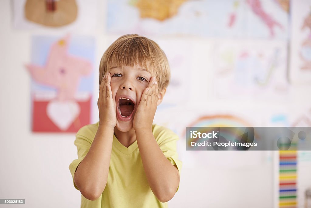 Oh No! A young boy cupping his face while screaming Child Stock Photo