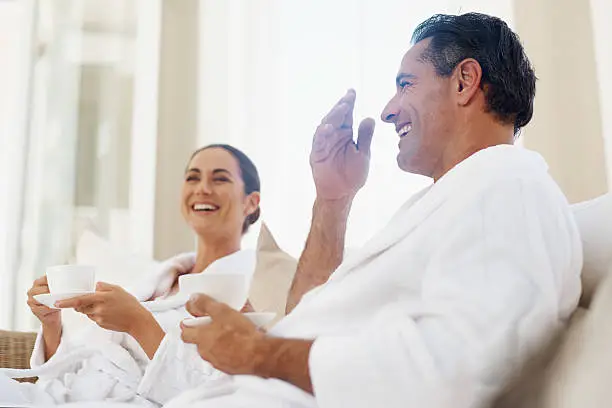 Shot of a loving mature couple enjoying a drink while relaxing together at a day spa