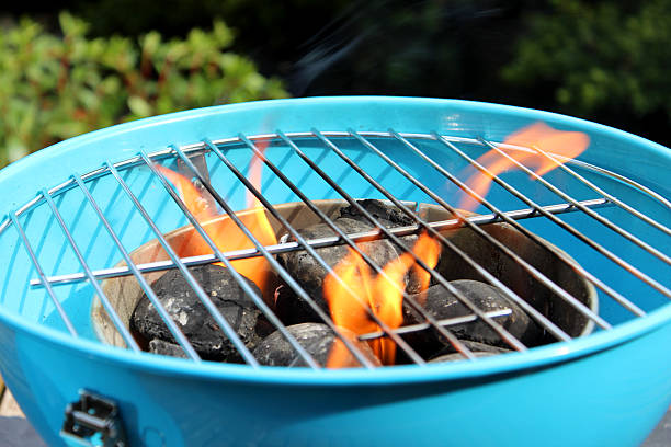 istock Lighting charcoal barbecue / BBQ image / flames on kettle barbecue coals 503028979