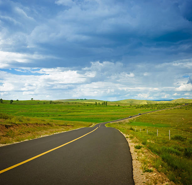 istock grassland and Country road 503029149