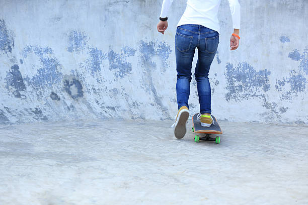 istock skateboarding legs at skatepark 503029448