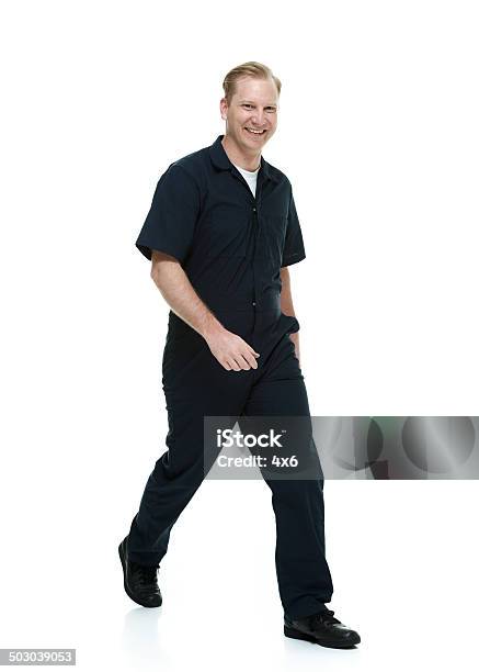 Smiling Mechanic Walking Looking At Camera Stock Photo - Download Image Now - 20-29 Years, Adult, Adults Only