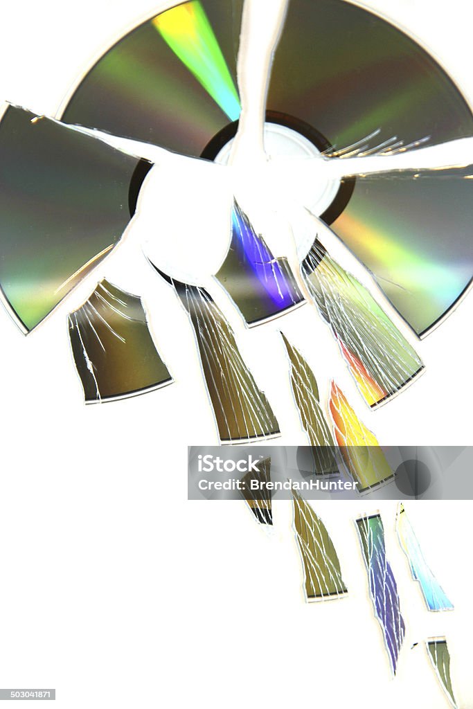 Death of Music A shattered CD on white.  Arts Culture and Entertainment Stock Photo