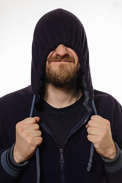 istock beard man pulled a hood over his eyes and smile 503045200