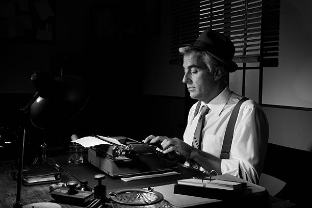 Professional handsome reporter working at office desk, 1950s style.