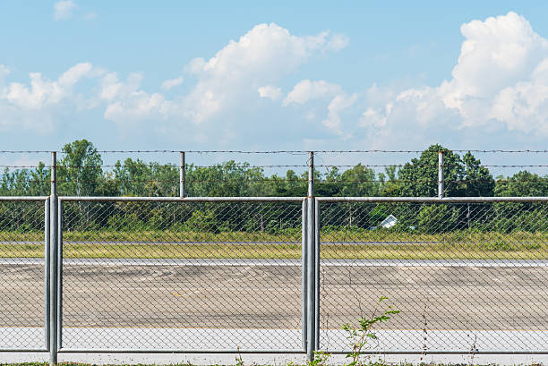istock steel mesh fence with barbed wire 503050408