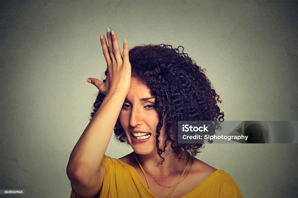 woman slapping hand on head to say duh made mistake Closeup portrait middle age woman slapping hand on head to say duh made mistake isolated on gray background. Negative human emotion facial expression feelings, body language Women Stock Photo