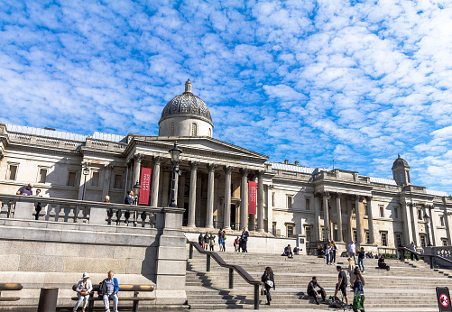 London, UK- June 4, 2015: Unidentified  tourists near  National Gallery in Trafalgar Square. The gallery houses a collection of Western European painting from the 13th to the 19th centuries.