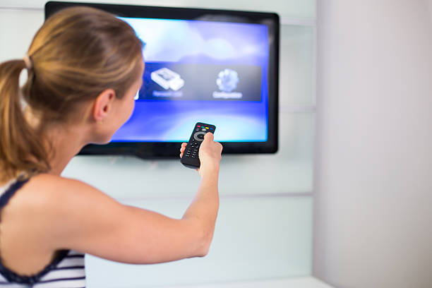istock Young woman at home watching TV 503053720