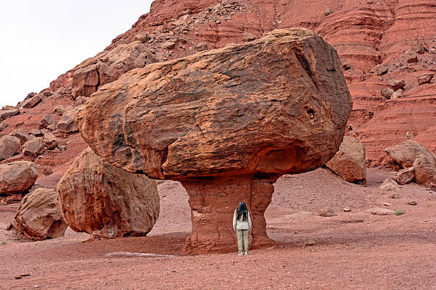 istock Hiker by a Large Balanced Rock in the Desert 503055784
