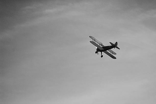 istock Biplane aircraft flying overhead in sky 503056706