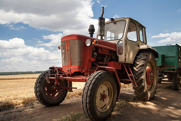 istock old tractor on the field, against a cloudy sky 503057332