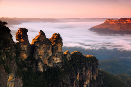The Three Sisters in Katoomba, NSW, Australia, with some early morning fog around them.