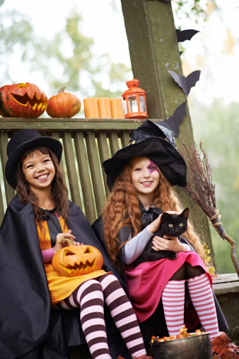 Happy Halloween witches holding Jack Olantern and black cat