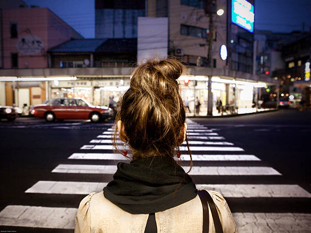 istock Woman's back crossing a pedestrian crosswalk 503072661