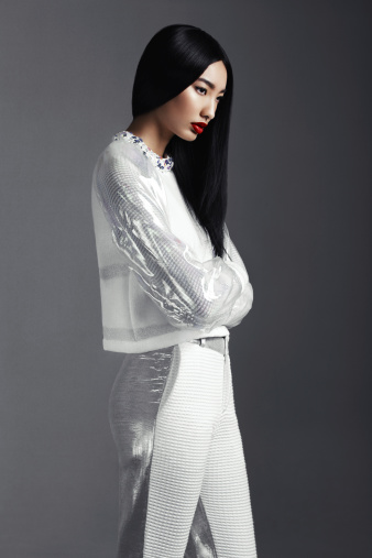 Beautiful asian woman wearing trendy white suit. Professional make-up and hairstyle. High-end retouch.