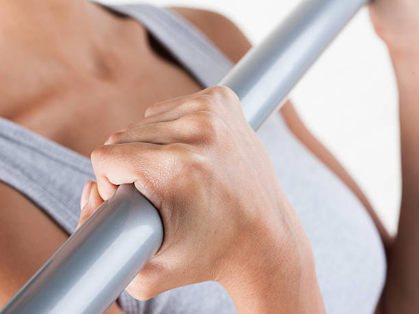 istock Young woman exercising with metal bar 503073808