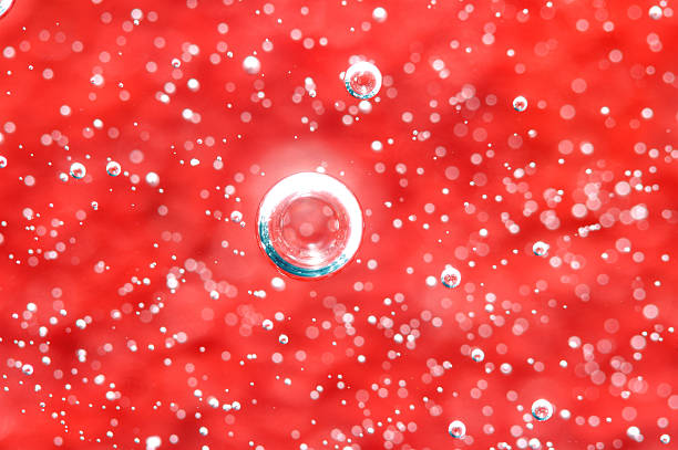 Air bubbles in a liquid. Abstract red background. Macro