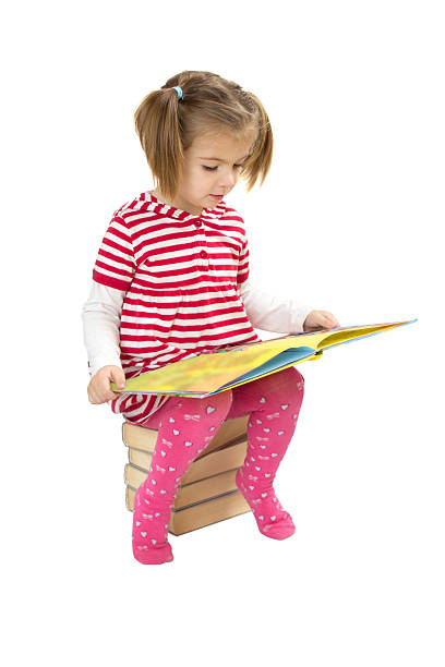 istock Child reading pile of books 503076284