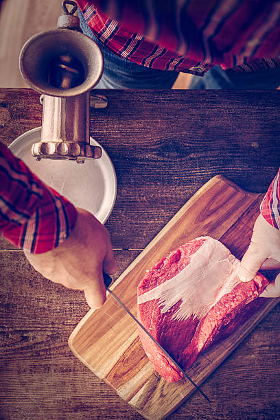 istock Cutting Fresh Meat to Ground it in a Mincer 503077930