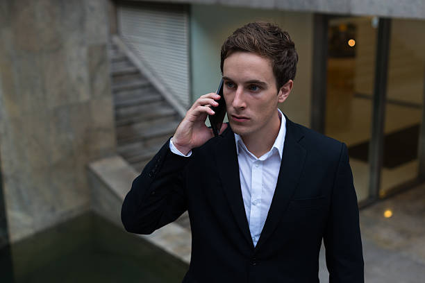 istock Businessman talking on mobile phone outdoors 503078560