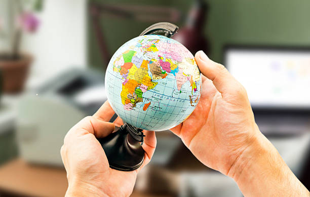 istock globe in the hands on the background blurred office background 503078752