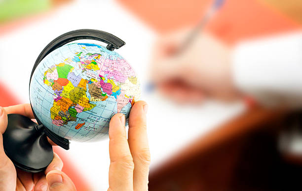 istock globe in the hands on the background blurred office background 503078760