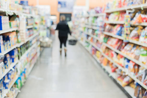 istock defocused grocery store aisle with person 503080486