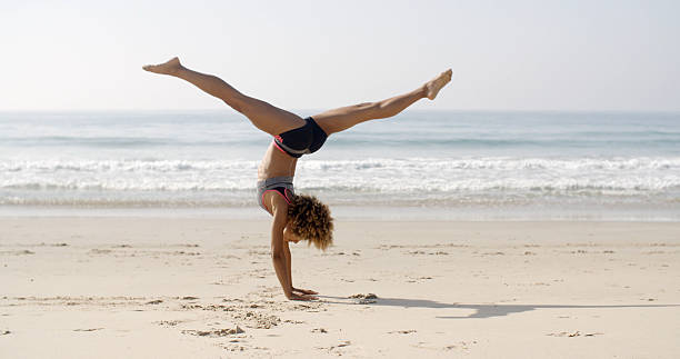 istock Young Woman Doing Cartwheel On The Beach 503080700