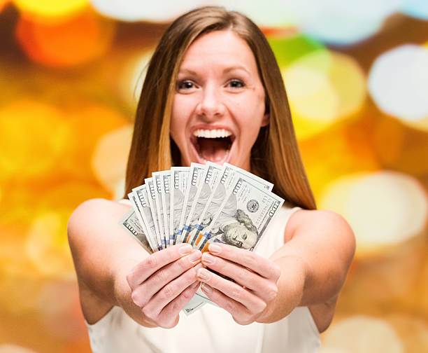 istock Excited woman holding money 503080766