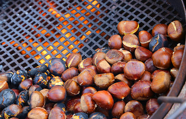 istock many chestnuts roasted in giant pan on the fire 503081026