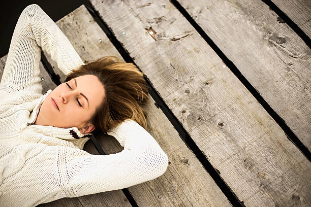 istock Girl lying down on a pier 503082158