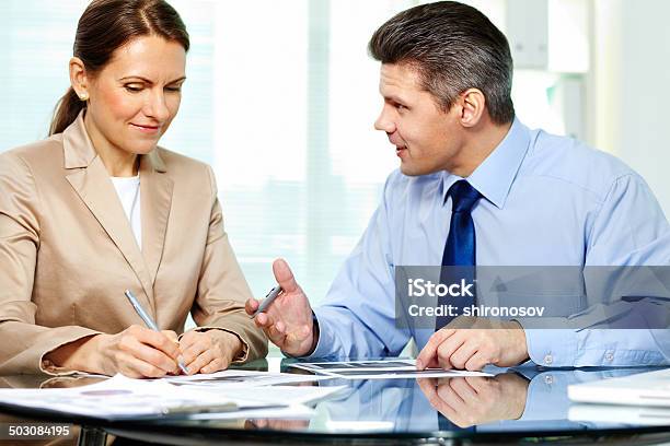 Discussing Papers Stock Photo - Download Image Now - Adult, Asking, Beautiful People