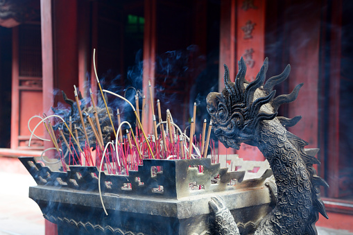 Burning incense sticks in temple, Vietnam